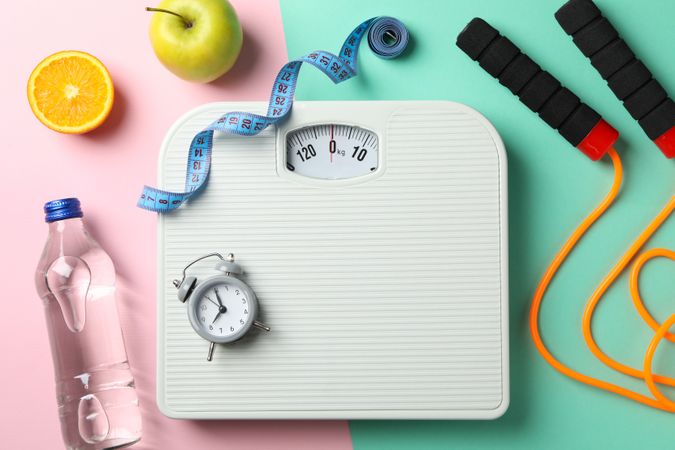 Weight loss or healthy lifestyle accessories on two tone background