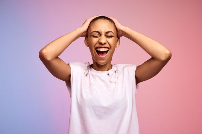 Happy woman with shaved head on gradient background