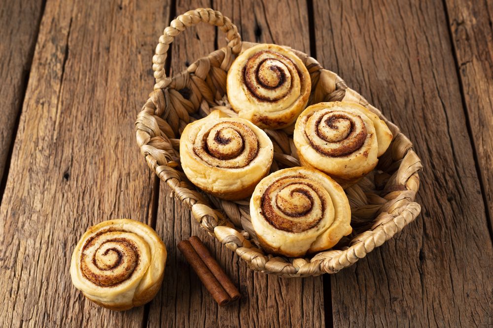 Cinnamon rolls on wooden background.