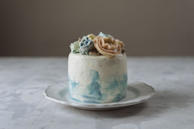 Buttercream flowers cake, blue and pastel peach colors