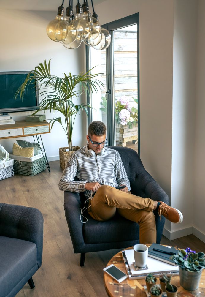 Man sitting in an armchair with tablet