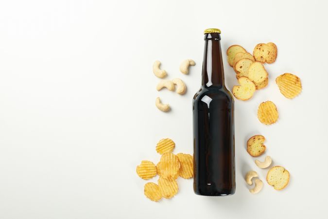 Concept of beer and snacks on light background