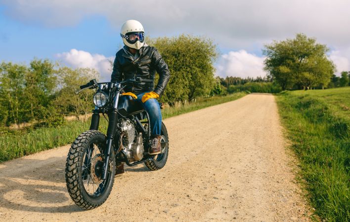 Man with helmet riding custom motorbike