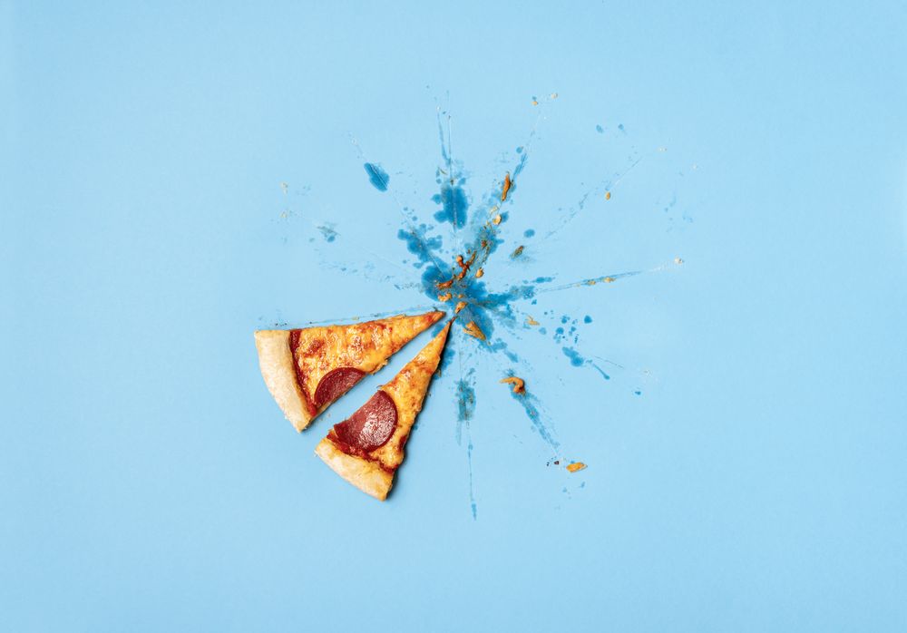 Two pizza slices on greasy table