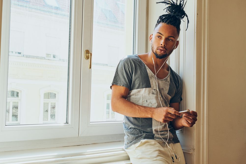 Cheerful Black male listening to music