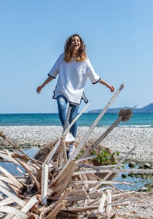 Young woman walking near dried plants