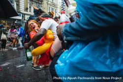 Young red haired woman laughs during attempted kiss in street party 41lQ75