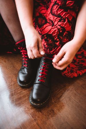 Woman in dress lacing boots