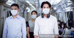 Asian people in facemask standing in metro car 42wZxb