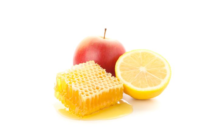 Honeycomb, apple and lemon isolated on neutral background