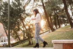 Young woman walking on border in park