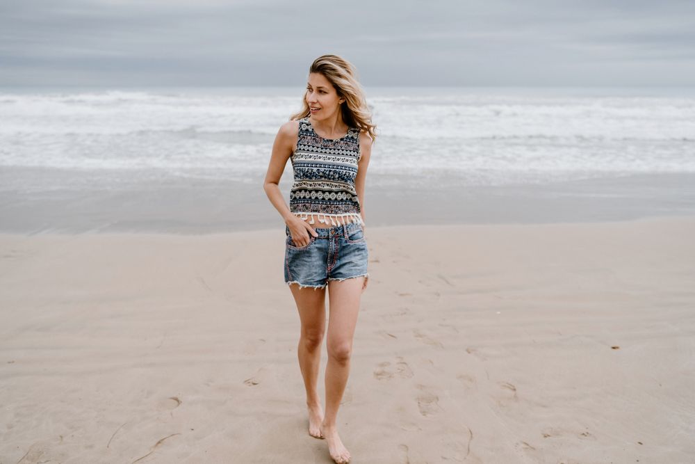 Happy female posing on sandy beach