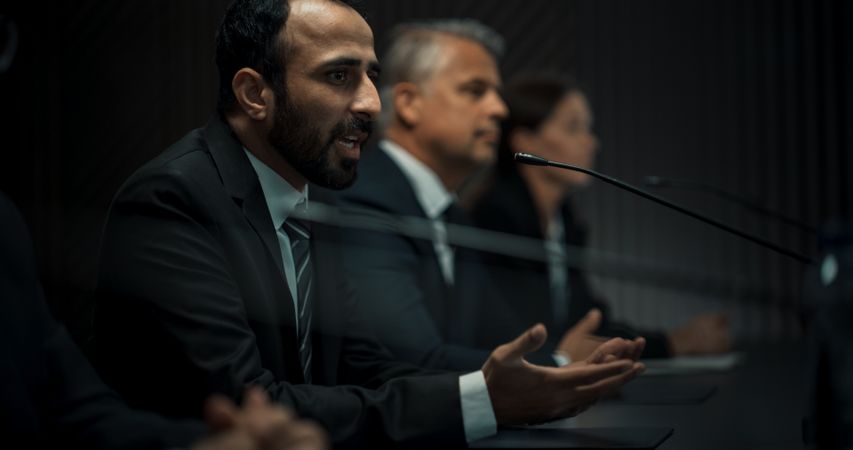 Multiethnic Male Head Of Political Delegation Speaking At International Economic Forum Press Conference.