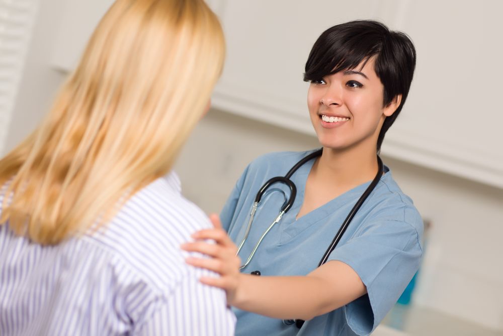 Young Female Doctor Talking with Patient