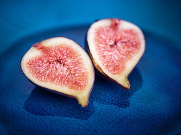 Closeup of ripe figs on blue plate