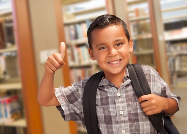 Hispanic Student Boy with Thumbs Up in the Library
