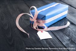 Blue present with pink ribbon and blank gift tag 42OW1b
