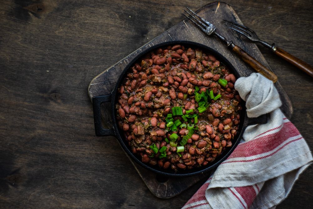 Top view of traditional Georgian lobio dish in cast iron pan on with kitchen towel