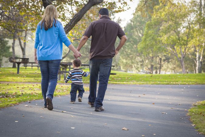 Happy Family Walking In The Park