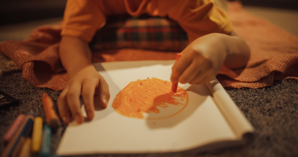 Artistic Child Painting And Coloring An Orange Or A Sun At Home In Cozy Authentic Apartment.
