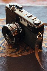 Vintage photo camera on fabric
