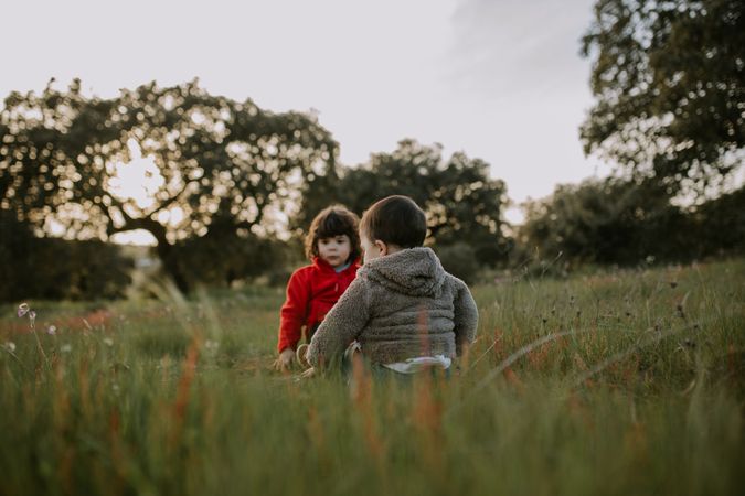 Two young children together in a park