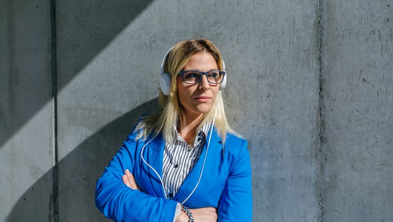 Businesswoman with headphones posing