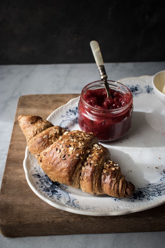 Served breakfast meal with croissant and jam