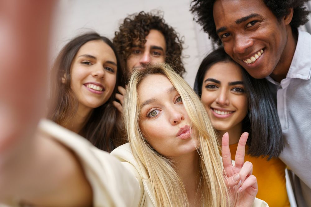 Smiling friends taking a selfie outside