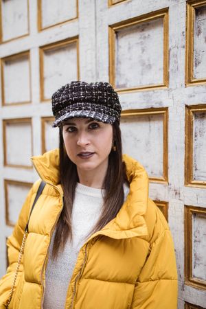 Stylish female near shabby wall on street