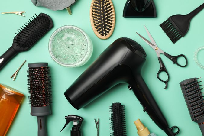 Composition with hairdresser accessories on mint background, top view