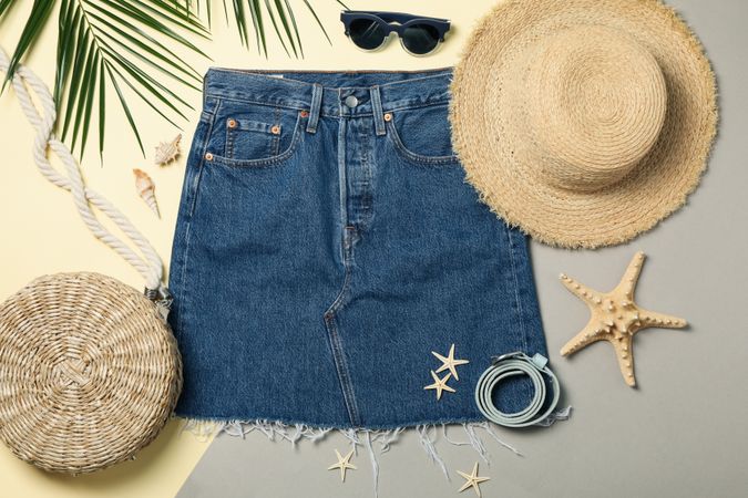 Summer vacation accessories on two tone background, top view