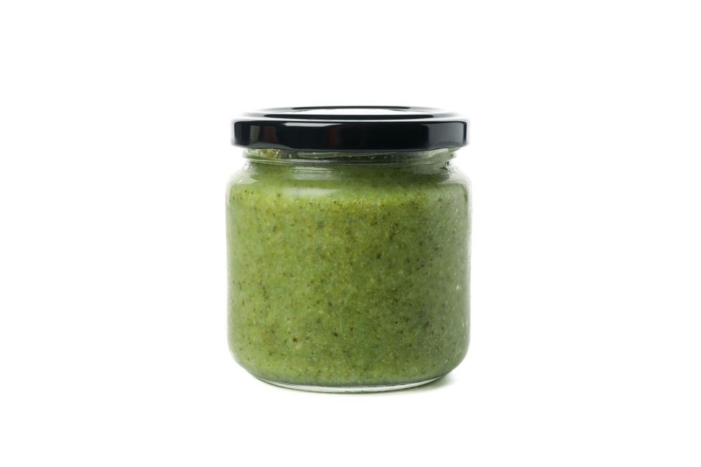 Glass jar with healthy baby food isolated on plain background