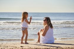 a woman with her daughter by the seashore