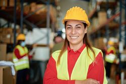 Confident Warehouse Worker Smiling in Industrial Environment