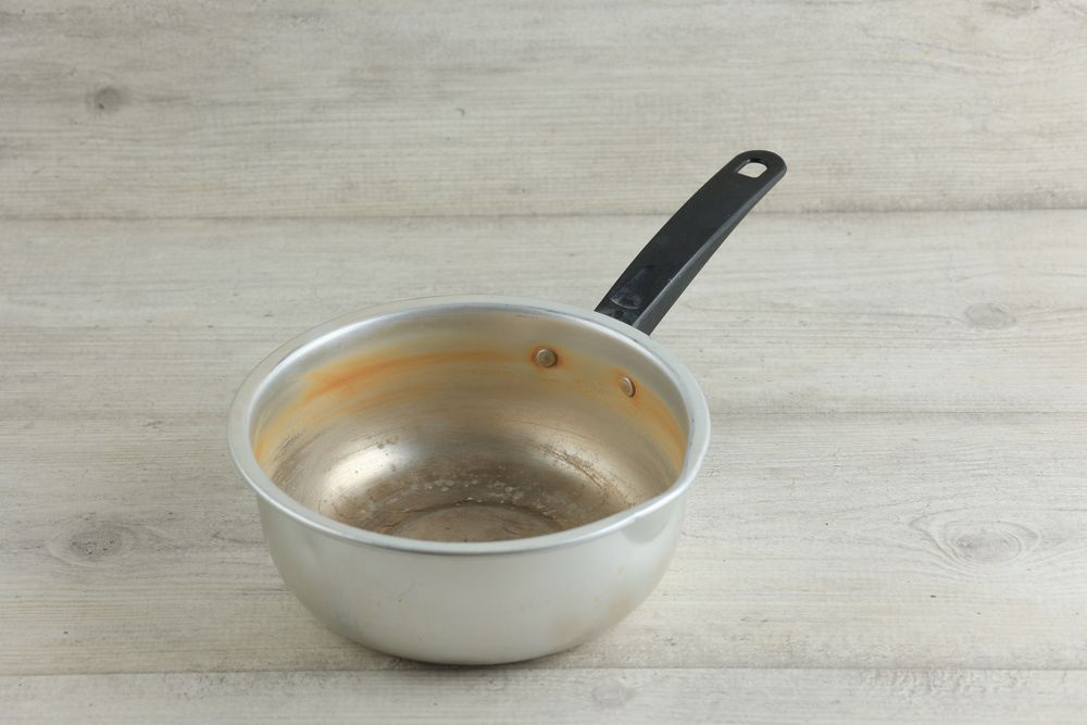 Old Used Stock Noodle Sauce Pan on Wooden Table