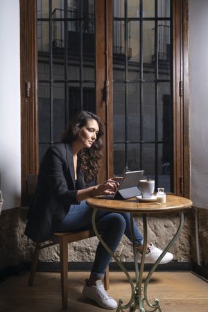 Young female using digital tablet in cafe
