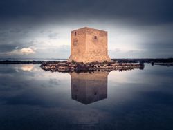 Wonderful watchtower in calm lake on cloudy day
