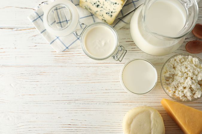 Flat lay. Different dairy products on wooden background, copy space