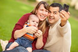 Happy Parents and Baby Boy Taking Self Portraits at the Park
