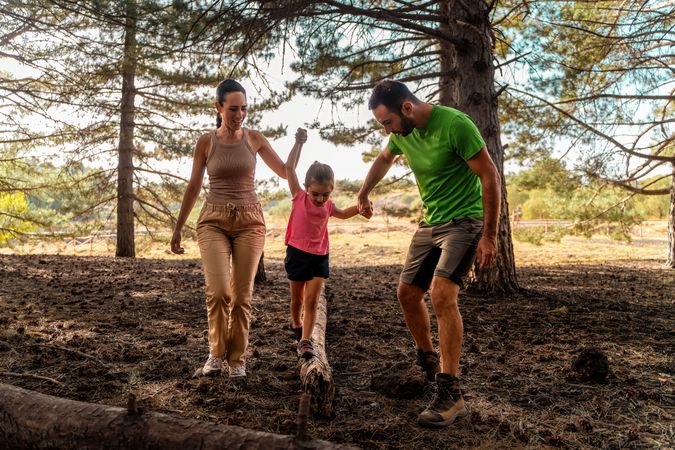 Family Walking Together in Forest - Outdoor Adventure and Bonding Time