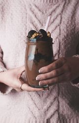 Crop woman with jar of chocolate mousse