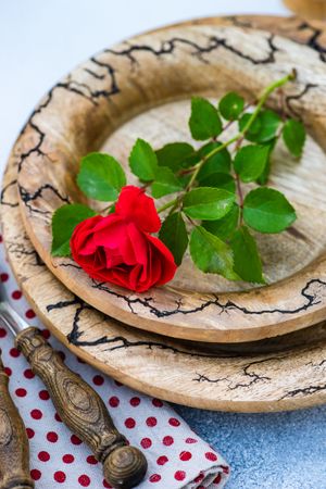 Brown table setting with red rose