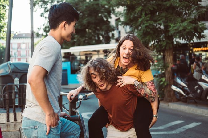 Carefree multiracial friends having fun on street