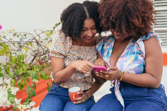 Two Friends Using Smartphone On the Street
