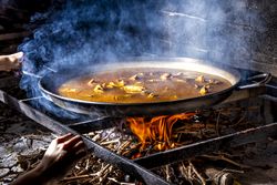 Process of cooking paella on fire