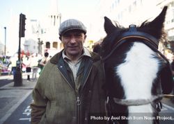 London, England, United Kingdom - March 19 2022: Man in tweed hat with pony 0KOzA0