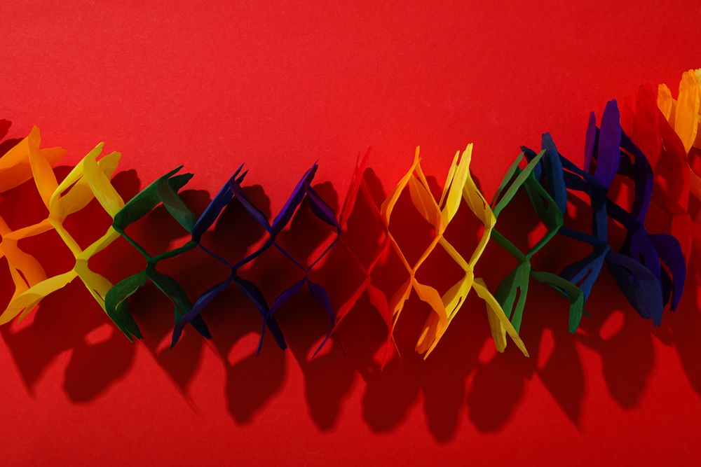 Pride parade concept, colorful symbols on red background.