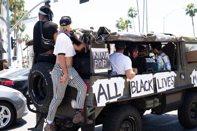 Los Angeles, CA, USA — June 14th, 2020: people ride in Army truck at All Black Lives Matter protest