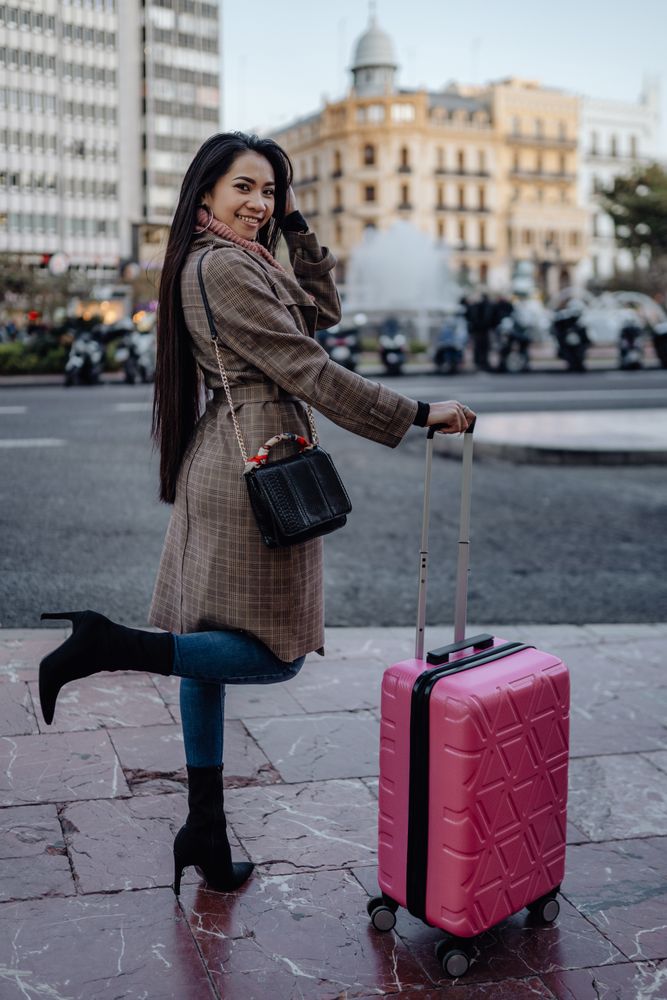 Asian tourist on sidewalk in city
